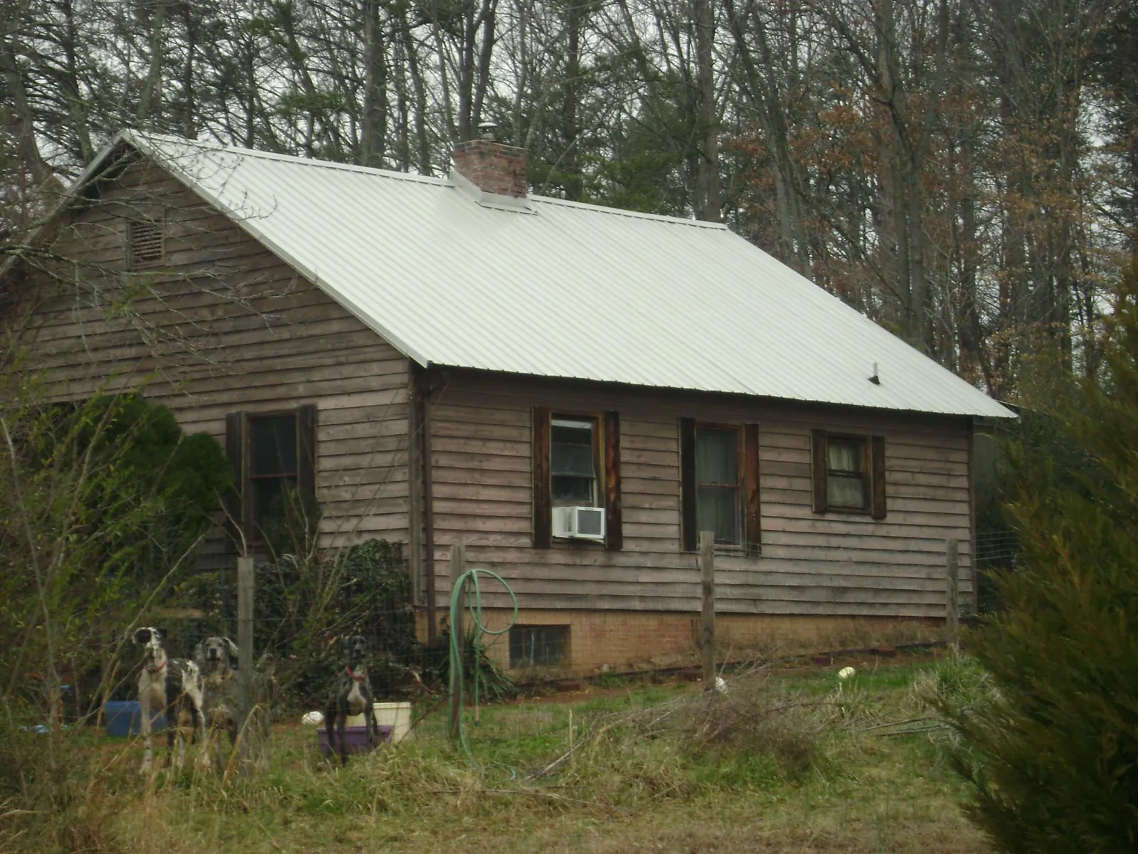 White metal roof on an old wood sided farmhouse, from a Metal Roof Installation job in Parrottsville